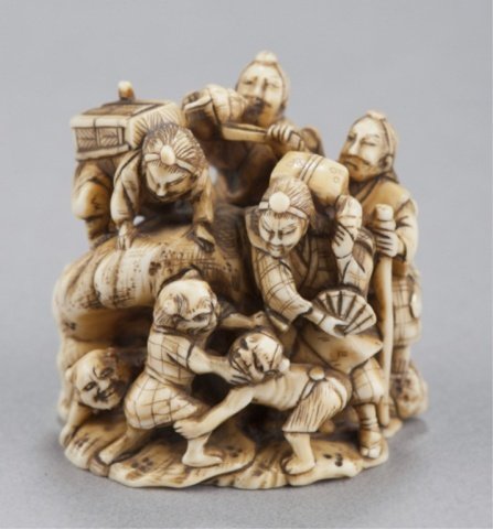An ivory netsuke of Shutendoji as priests on conch: By Gyokutoshi. Mid 19th century. A grouping of eight (?) Shutendoji as priests clambering over a large conch shell. Signed on the underside between the himotoshi in a double oval reserve, Gyokutoshi.1