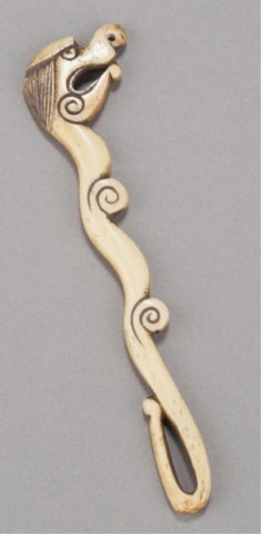 A bone sashi netsuke of rain dragon.: Asakusa school, Mid 19th century. Simplified form, a good patina developing on the back side. Unsigned. 5 3/8in (13.6cm). Provenance: Purchased from Raymond Bushell 1957.