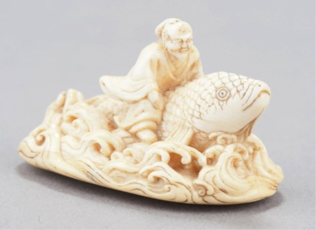 A marine ivory netsuke of Kinko.: Early 19th century. Riding a giant carp through the waves as he returns from his trip under the water, the waves are well detailed with whitecaps, moderate wear. Unsigned. 2in (5.1cm).