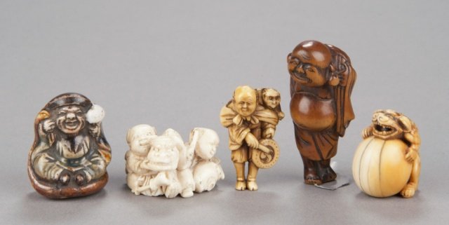 A group of five netsuke, various materials.: The first, mid 19th century, in porcelain, Daikoku with mallet raised. 1 1/2in (3.9cm). The second, 19/20th century, in ivory, two Karako. 1in (2.4cm). The third, mid 20th century, in ivory, Sarumawas