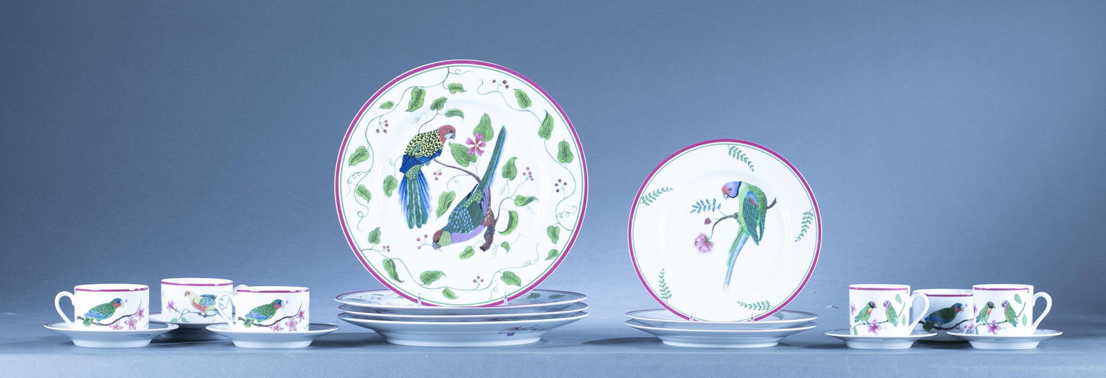 Chase, "Parrots of Paradise" partial service, 1989: An eighteen piece Lynn Chase "Parrots of Paradise" partial porcelain service. Includes four 2 1/4" coffee cups with three saucers, two 2 3/8" teacups with two saucers, four 10 7/8" dinner plates, and 
