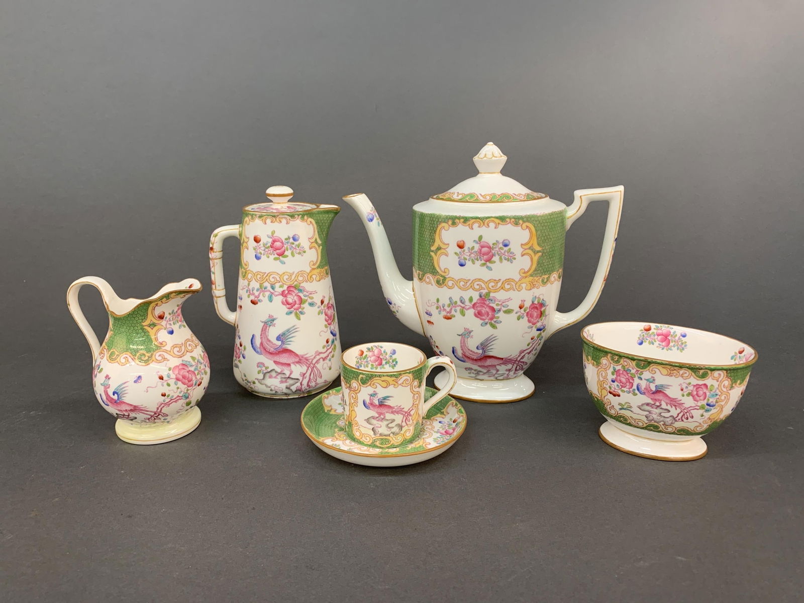 Minton Cockatrice Green tea set.: A Minton tea set in Cockatrice Green pattern. English, 20th century. Stamped on underside. Including six demitasse cups 2" and five saucers, open sugar bowl 2 1/2", teapot 7 1/4", creamer 6", and mini