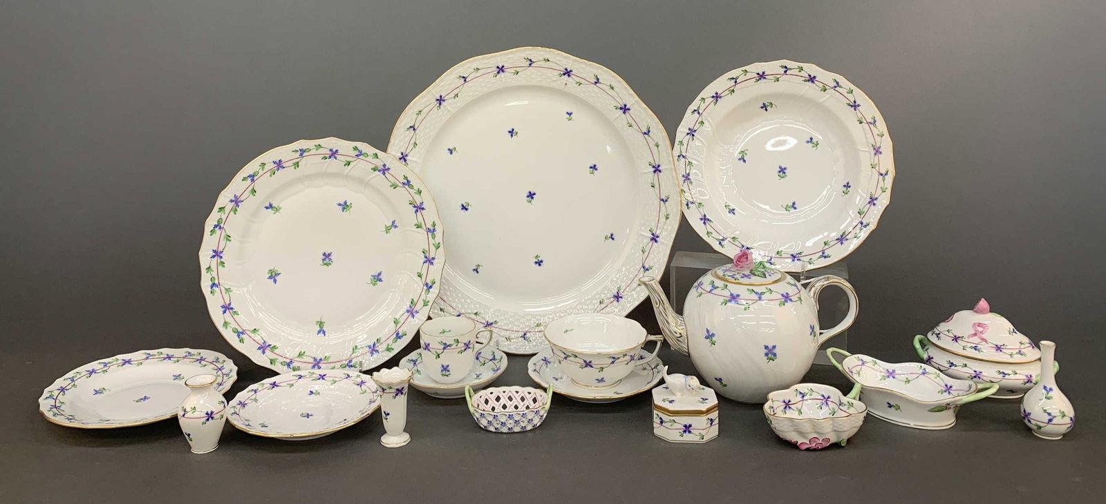 Herend "Blue Garland" service.: A set of ninety-one Herend "Blue Garland," porcelain tableware pieces. Late 20th century. Hungary, Gilt trim accent. Shield mark and style code on base. twelve dinner plates 10 1/4", twelve soup bowls