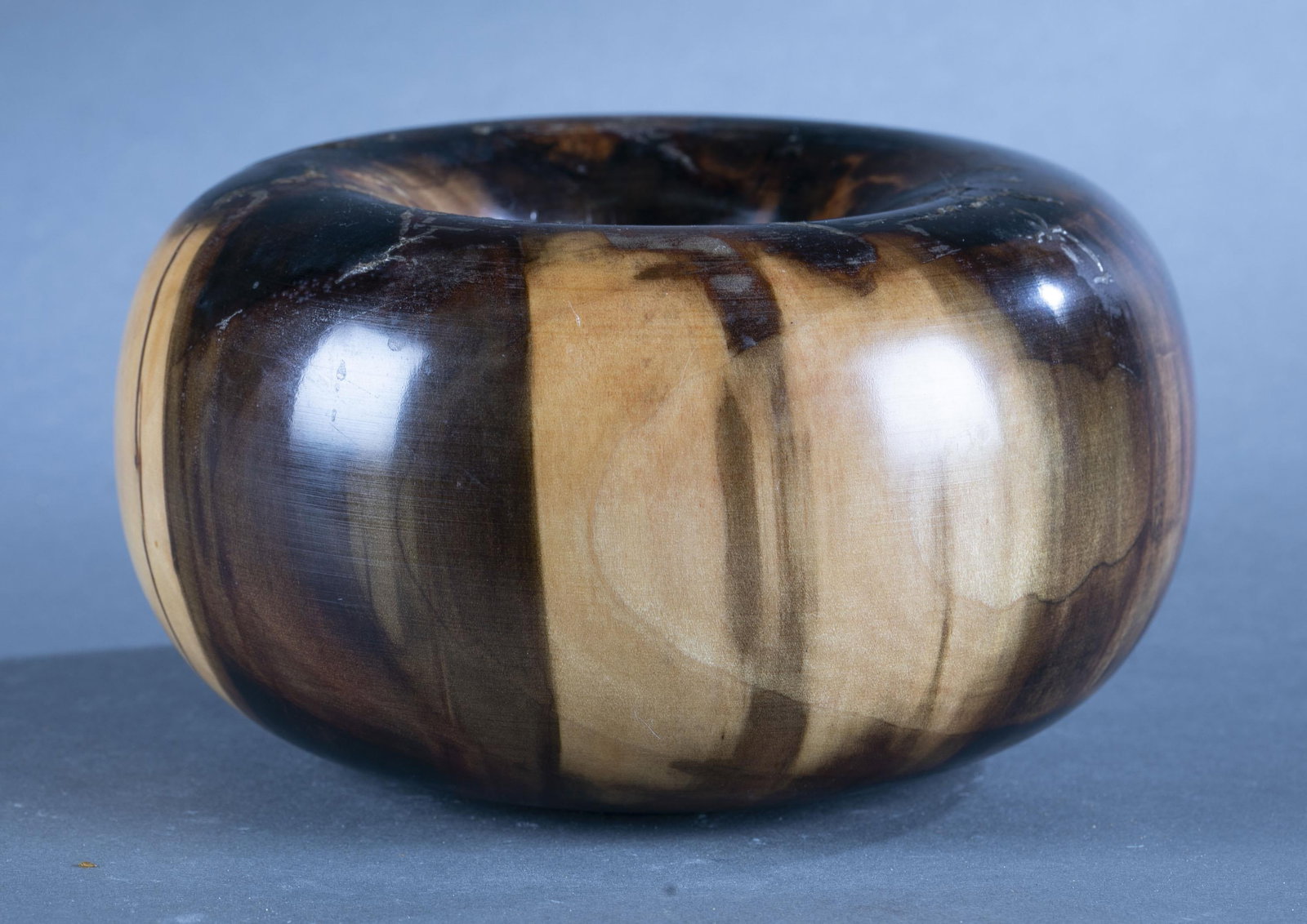 Ed Moulthrop, turned tulipwood donut bowl: An Edward Moulthrop (American, 1916-2003) turned tulipwood donut bowl. 217881-R. Signed and stamped on base. 4 3/4" x 8 1/2" Condition: some flaking and clouding