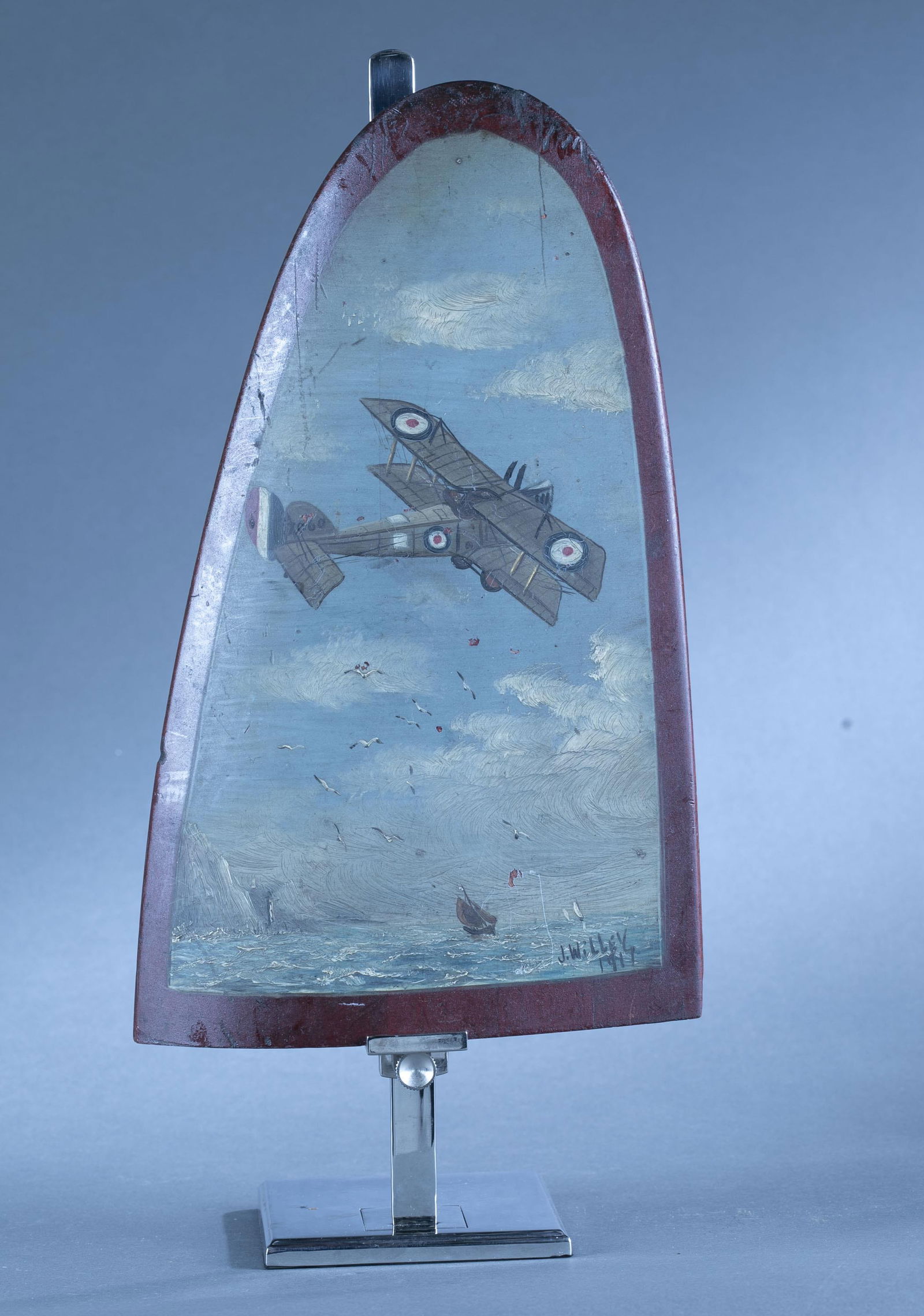 J. Willey airplane propeller: A trench art J. Willey (English, 1916-1917) oil painted airplane propeller of a French biplane. Signed l.r. "J. Willey/ 1917." 14 1/4" x 9" x 1" Crack on one side.