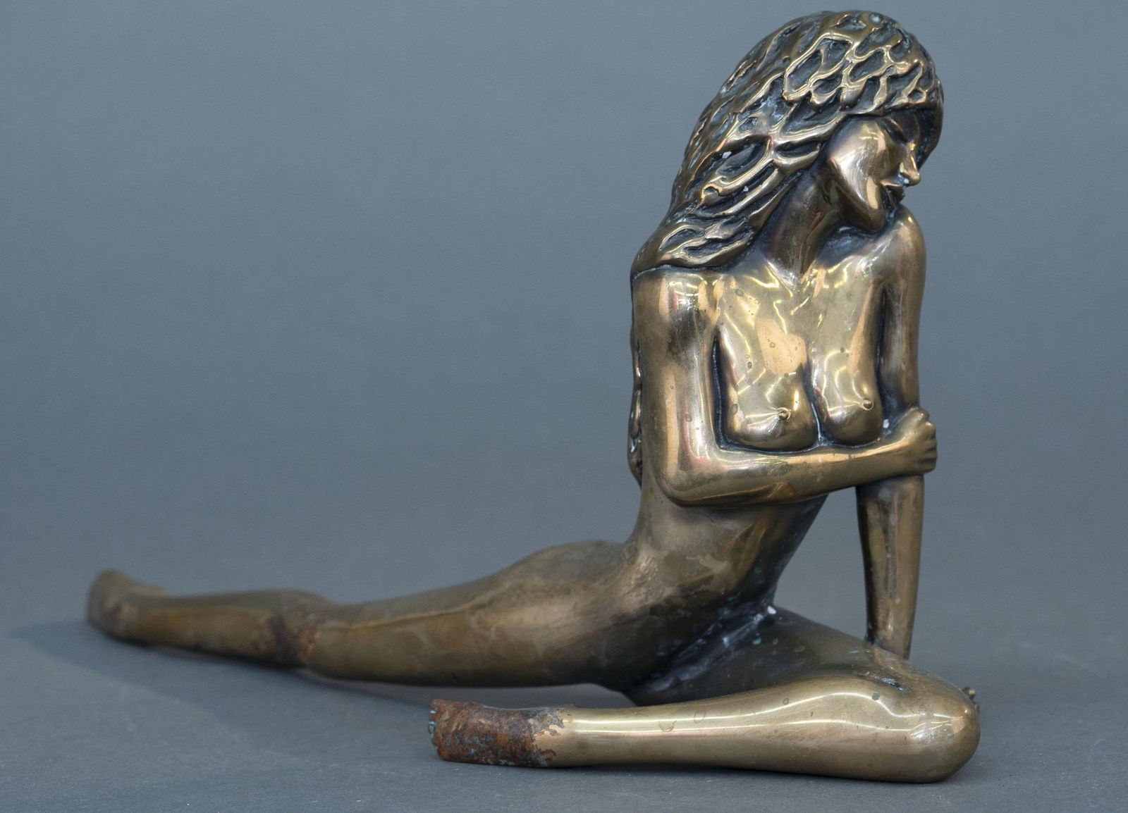 Tom Bennett, "Autumn," bronze.: Tom Bennett (American, active late 20th century). "Autumn." A nude female bronze sculpture. Edition 152/250. 1988. Signed, dated, and editioned on foot. 9 1/4" x 18". Patina and marks, fingers bent.