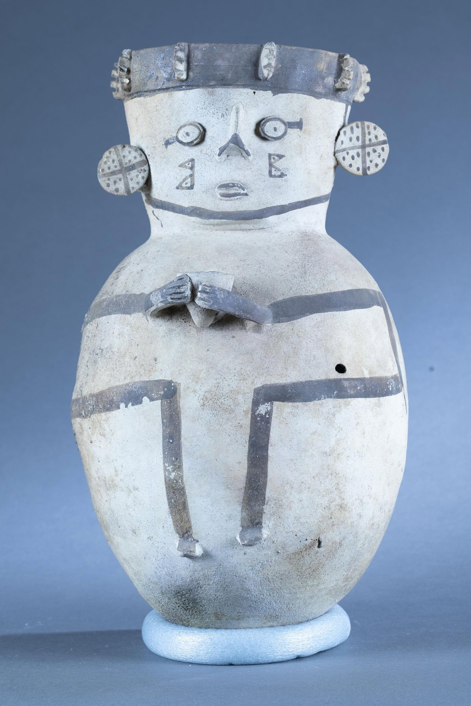 Chancay figural vessel, Peru.: A Chancay vessel of a figure holding a cup. Peru. 17" x 10". Provenance: From the collection of Dale Spoor.