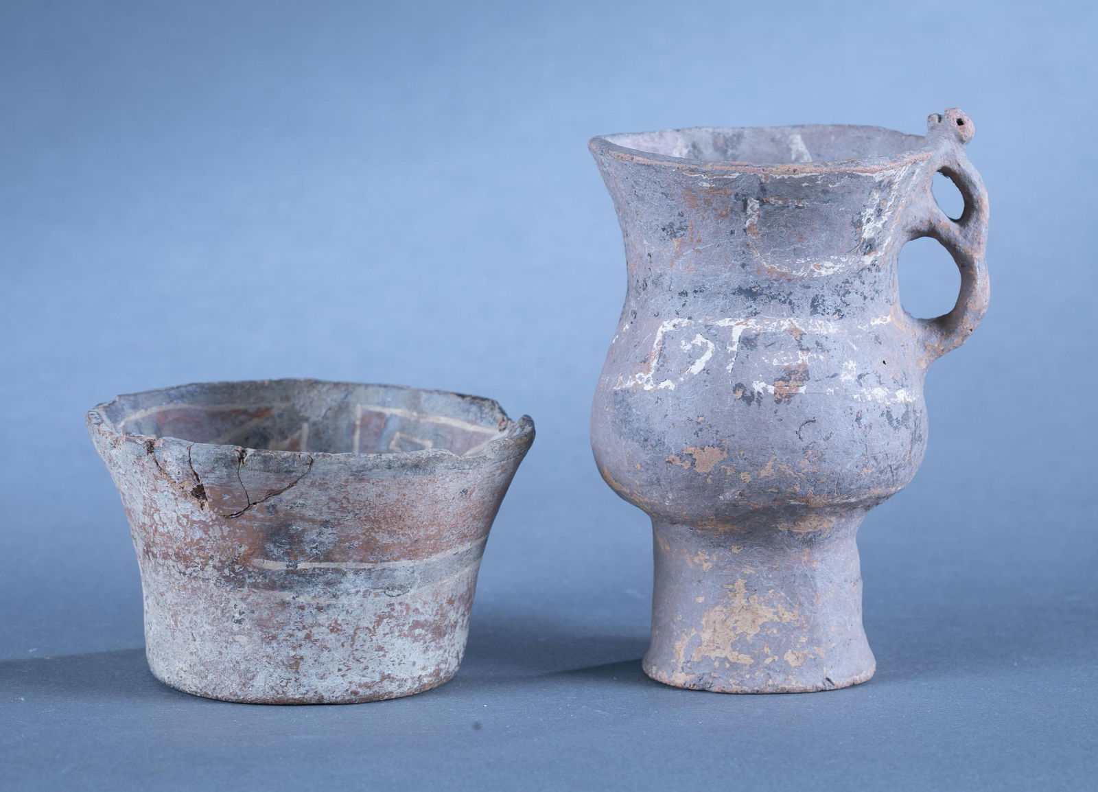2 Pre-Columbian vessels.: A group of two Pre-Columbian vessels. Including a bowl and a vase decorated with geometric patterns. Largest: 6 1/4" x 4 3/4". Condition: Abrasions, surface dirt, and loss. Provenance: From the collec