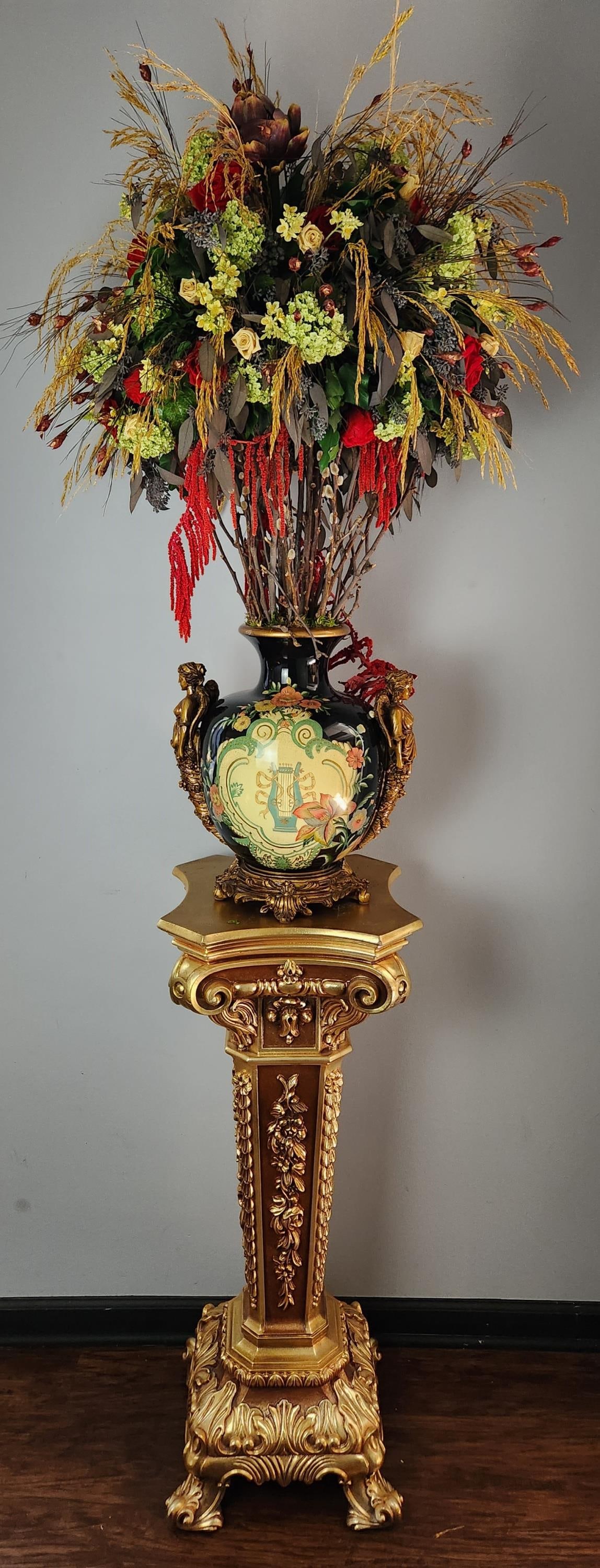 Contemporary jardiniere on pedestal.: A contemporary Baroque style ceramic jardiniere with wood mounts on faux gilt wood pedestal with an arrangement of artificial flowers. Early 21st century. Stand: 39 1/2" x 15".