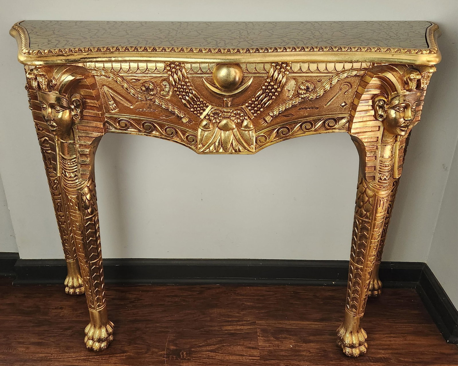 Contemporary Egyptian Revival console table.: A contemporary Egyptian Revival console table. Early 21st century. Glass topped. 34" x 43" x 14 1/4".