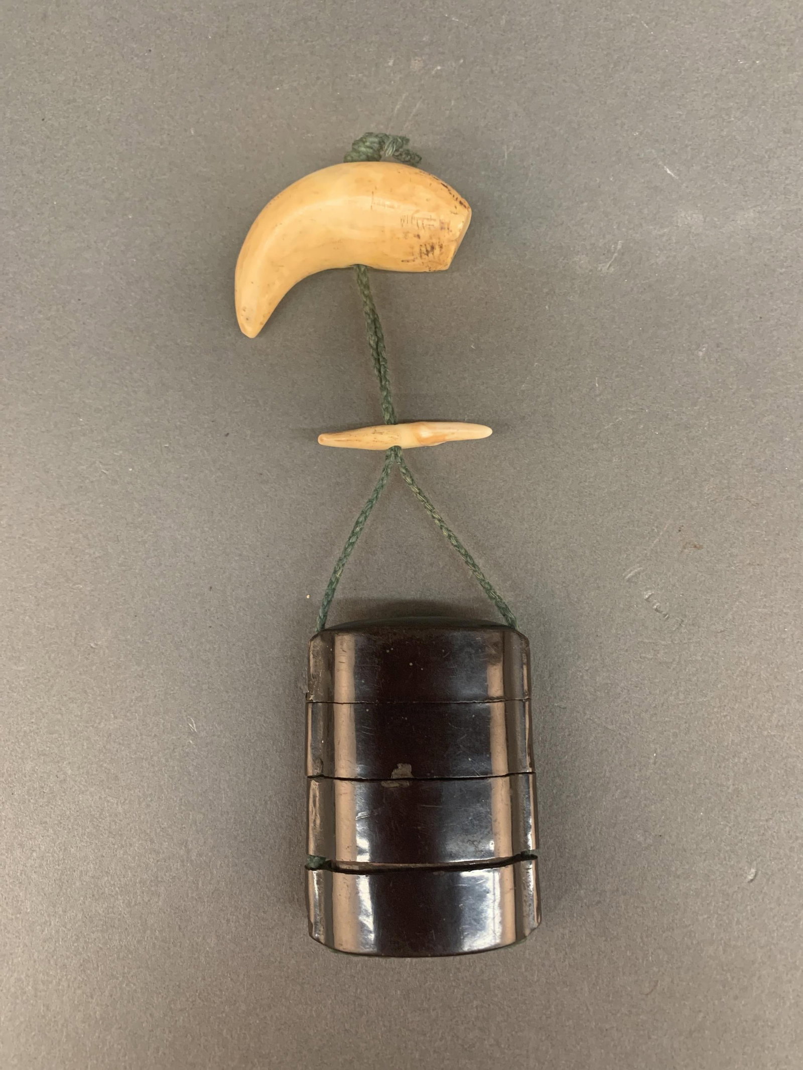Japanese inro.: A plain Japanese lacquer inro with tooth ojime and netsuke. 6" long. Inro: 2 1/2" x 2" x 3/4".