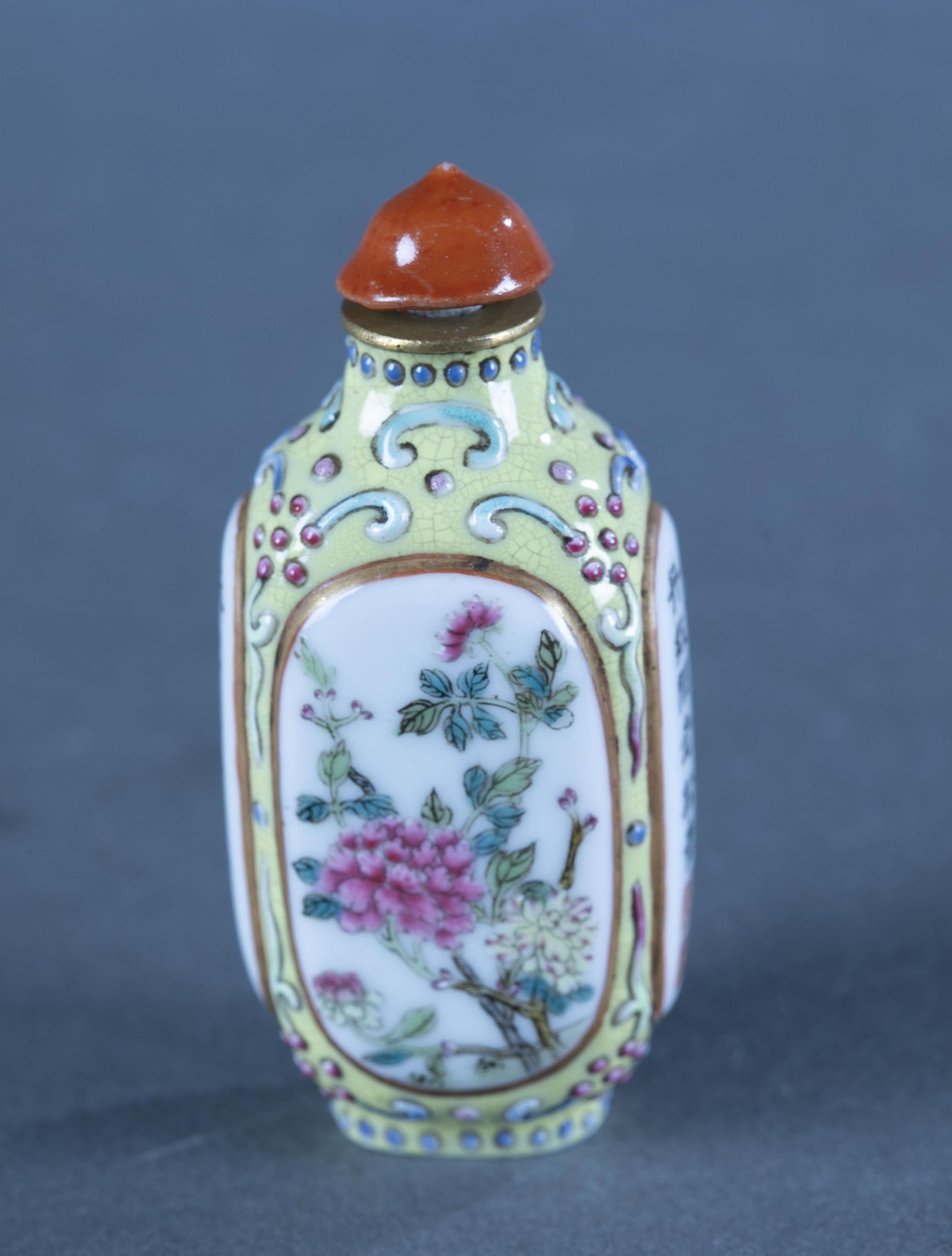 Painted snuff bottle.: A ceramic snuff bottles with painted floral sections. Marked on bottom. 2 3/4".