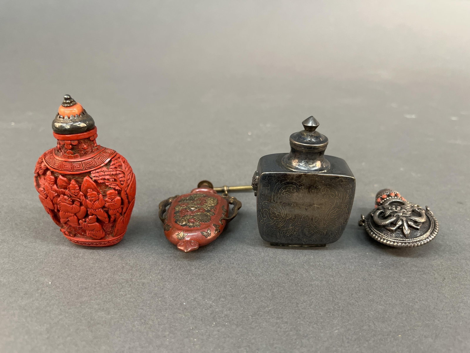 4 Snuff bottles.: A group of four snuff bottles. Largest: 2 7/8".
