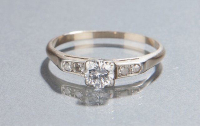 Diamond engagement ring.: A diamond engagement ring. Round brilliant-cut diamond .32 CT set in 14KT yellow gold. Clarity and color of this diamond are VS1 and F-G. Size 6 3/4. Tw 0.05 t oz.