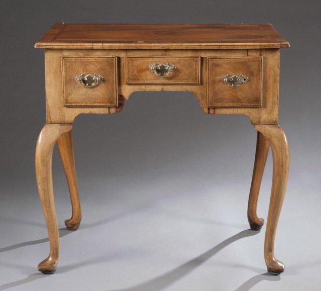 English George I veneered lowboy.: An English George I veneered lowboy. Three drawers above shaped apron on cabriole legs with slipper feet. c.1720. 27 1/2"h x 28 1/2"w x 19"d.