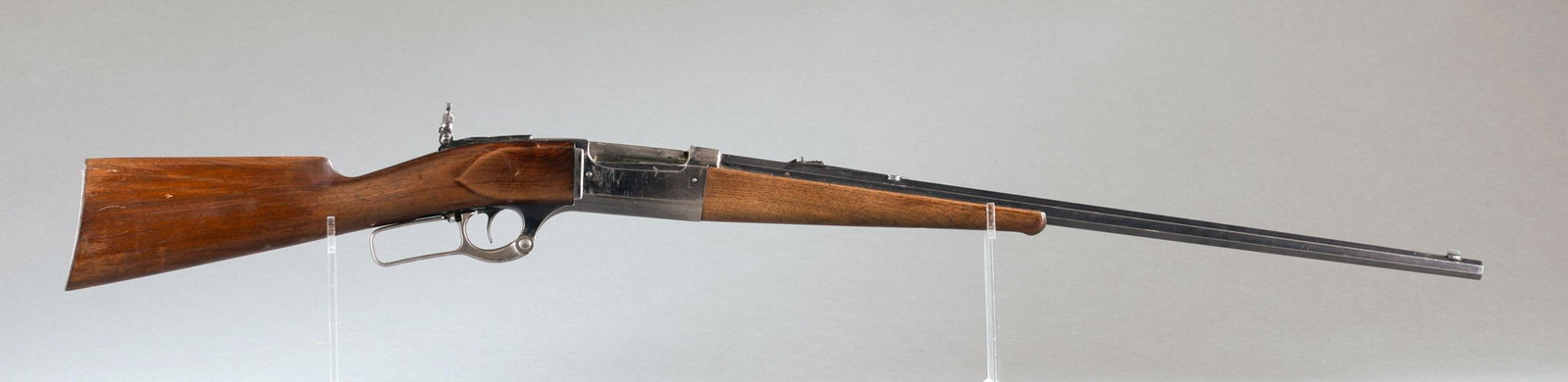 Savage M1899B lever action rifle, .303 Savage: [Modern Firearm] A Savage Model 1899 lever action rifle, .303 Savage. Circa 1904. Blued finish. 26" octagon barrel. Straight grip walnut stock with shot gun butt. Rear flip up aperture sight. Serial 4
