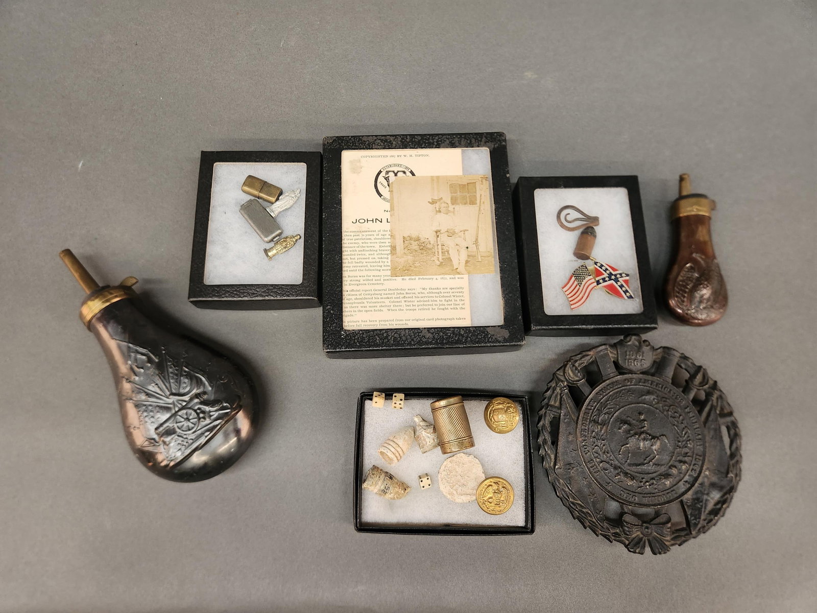 Civil War bullets, pins, and repro powder horns: A group of Civil War bullets, pins, reproduction powder horns, and reproduction CSA trivet. The bullets are carved.