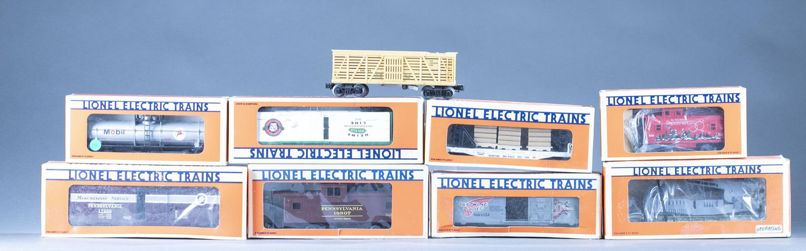 11 Lionel LLC O Gauge train cars: A group of eleven Lionel LLC O Gauge train cars. ++ Ten cars in boxes, including: No. 6-16272 1997 Christmas boxcar, No. 6-19945 1996 Holiday Boxcar, No. 6-19987 I Love S. Carolina boxcar, No. 19998