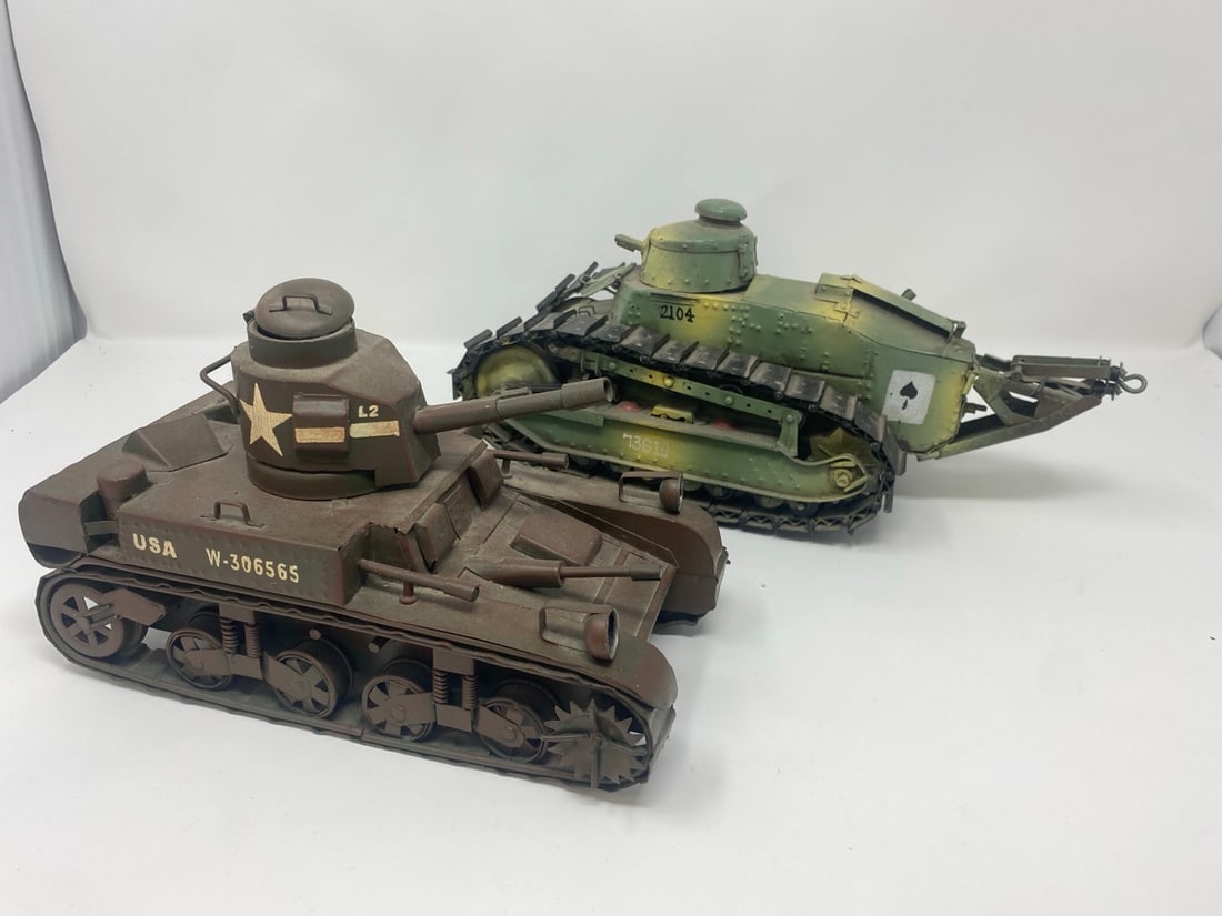 2 U.S. Army Tanks: A group of two U.S. Army tanks. 1940 M2 Olive made of metal . FT 17 Renault , Camouflage paint . Tanks were used in WWI by the US . Ace of Spade Insignia was George Patton's tank Squadron in WWI