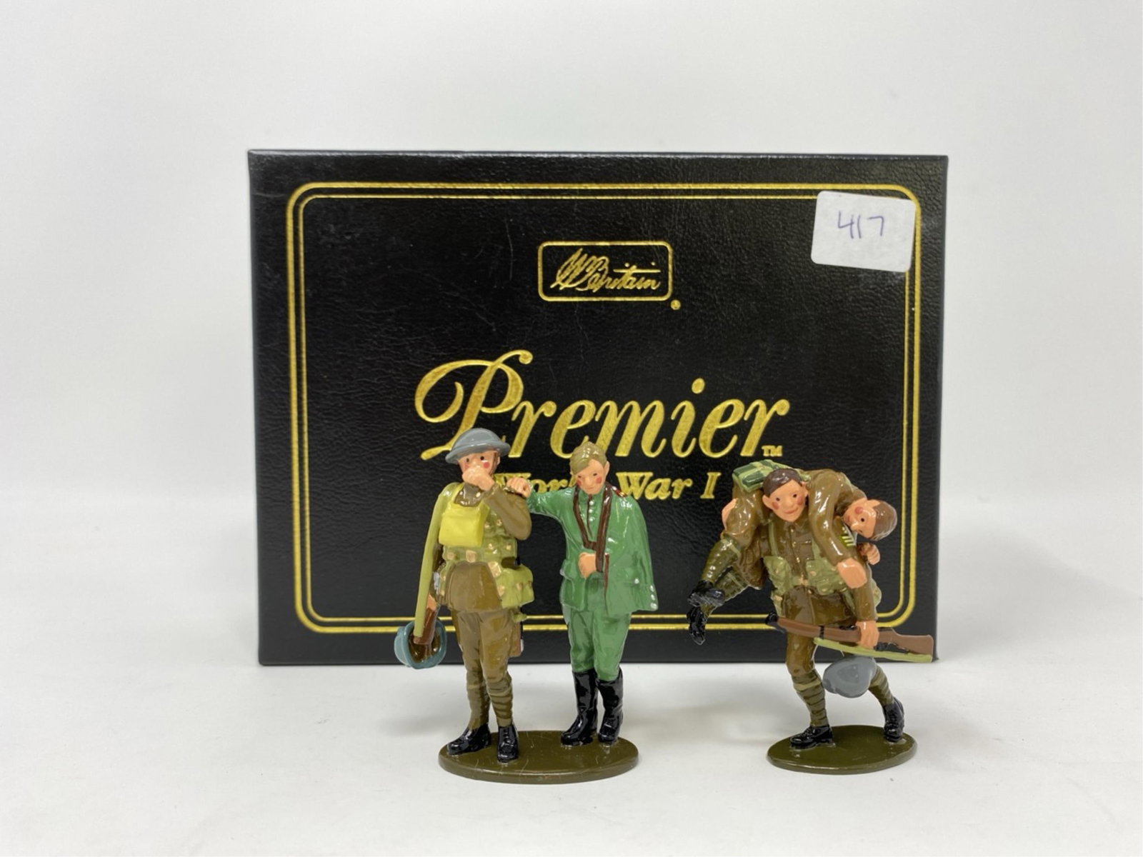 W Britain, WWI toy soldiers: A W Britain Premier WWl set of toy soldiers. No. 41030 Wounded man carried by Sergeant and British soldier helping German