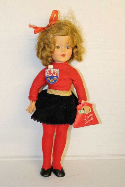 Ideal Shirley Temple doll 12" w/ original clothes. 1957: 1957 vinyl Shirley Temple doll with original branded Shirley Temple clothing including red shirt with badge, black velvet skirt with red gingham lining, red tights, and Shirley Temple purse with money