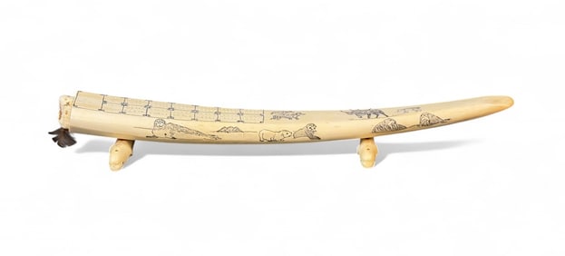 Inuit scrimshaw walrus tusk cribbage board.