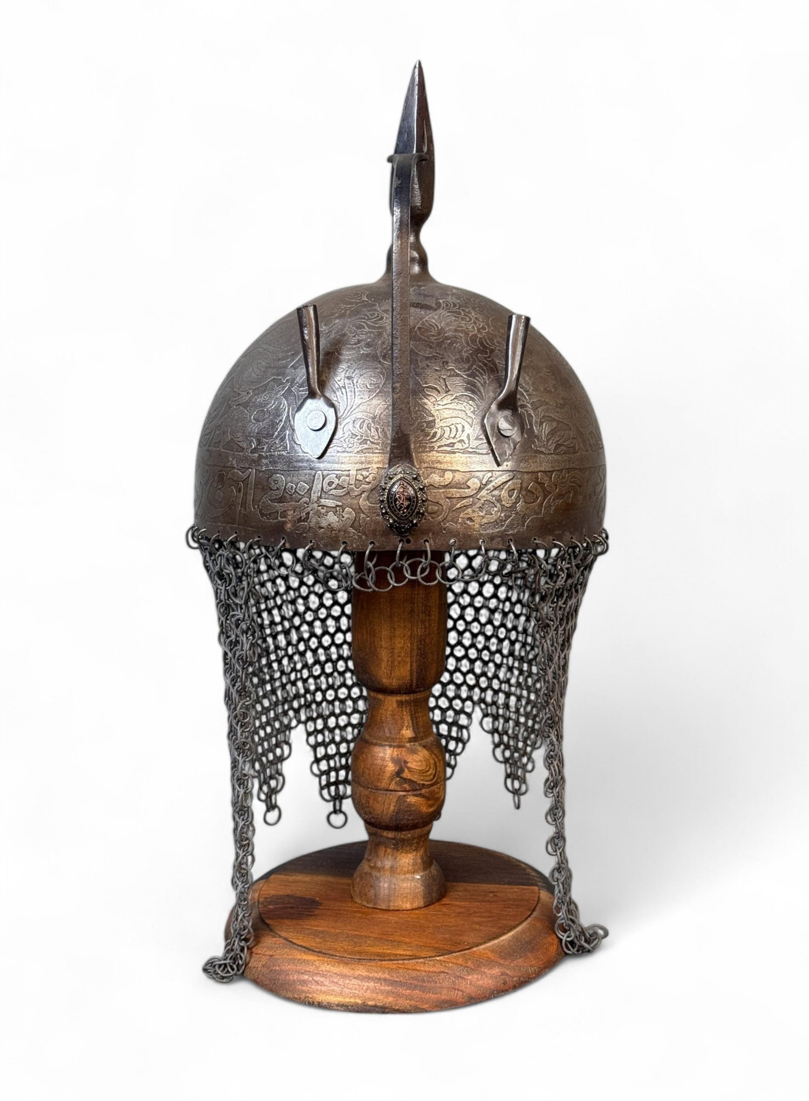 Indo Persian Kulah Khud helmet.: An Indo Persian Kulah Khud helmet. Circa 19th century. Chased decoration. 9" x 7 7/8".