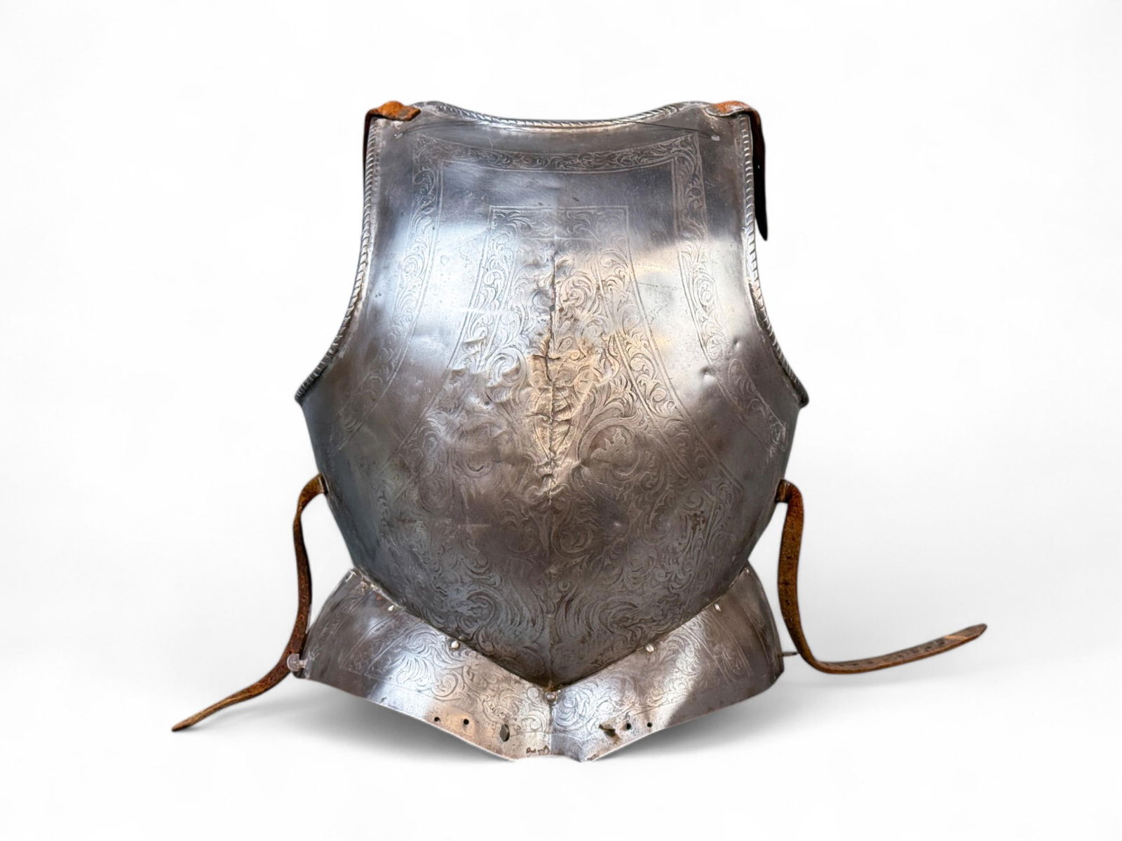 Early Modern Spanish etched parade breastplate.: An Early Modern Spanish etched floral parade breastplate. Circa 1700. 20" x 14 1/2" x 6 1/2". Condition: Crack down middle with repair.