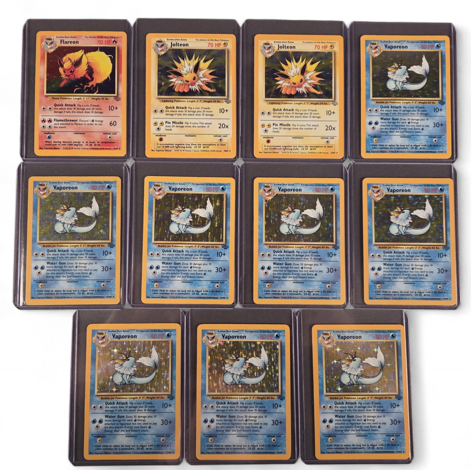 11 PTCG Jungle [Ultd] Flareon, Jolteon, & Vaporean: A group of eleven Pokemon TCG Jungle [Unlimited] holofoil cards. Flareon #3, two Jolteon #4, and eight Vaporean #12. Condition: Lightly to Moderately Played.