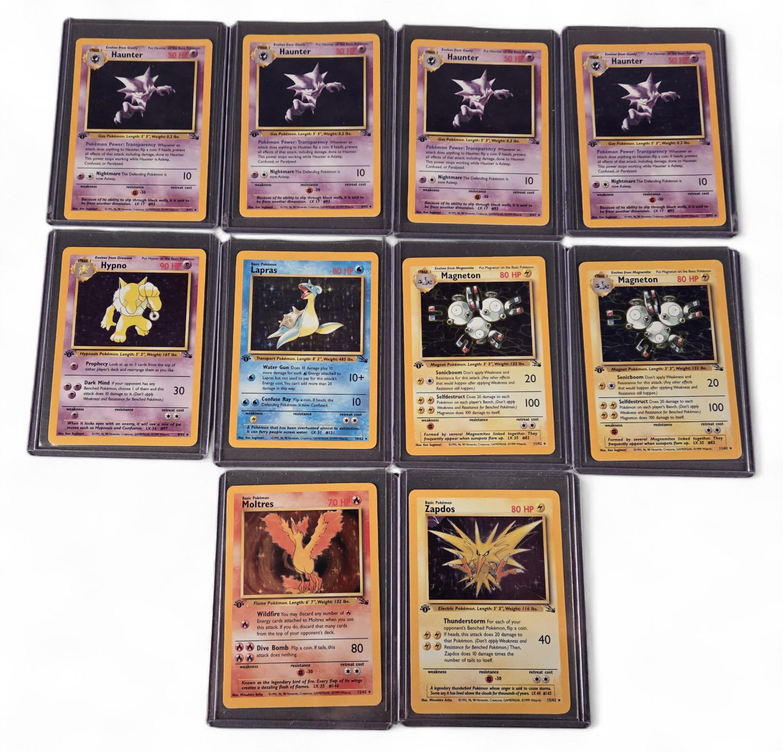 10 PTCG Fossil [1st Ed.] Holo Rare cards: A group of ten Pokemon TCG Fossil [1st Edition] Rare Holofoil cards. Including four Haunter #21, Hypno #23, Lapras #25, and two Magneton #26, Moltres #27, and Zapdos #30.