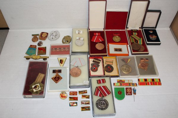 Large group of Soviet medals.: Includes pins, cap badges, medals with ribbons for various branches including Army, Air Force, police, Border Guard, KGB, etc. Includes East German and Russian.