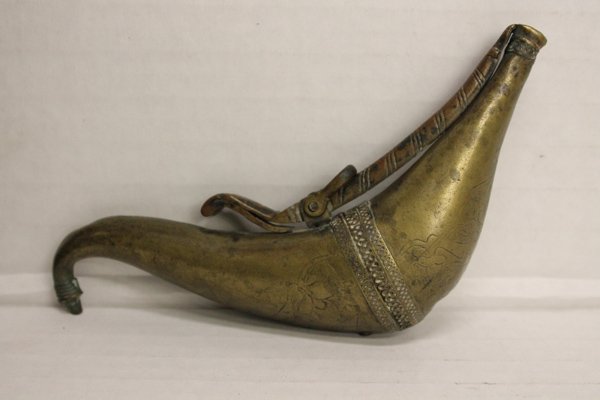 Middle Eastern brass powder horn.: Engraving throughout. Provenance: Purchase in Egypt c.1980.Purchase in Egypt c.1980.