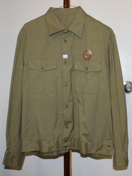Soviet military uniform shirt with metal pin.: Size large Army green button up uniform shirt with metal Soviet USSR pin on breast pocket. From a Deceased Russian Colonal Valery Kuzman (1943-2001). Served in the Soviet military intelligence.Provena