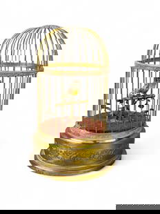 French singing bird automaton, c. 1900.: A French singing bird automaton. Circa 1900. Marked "Made in France." 10 1/4" x 6 3/4". Condition: Finial detached. Missing feathers on bird. Working condition. Provenance: From the Estate of