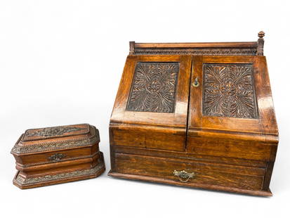 2 carved wood secretarial containers.: A group of two carved wood desk top containers. 20th century. ++ Rectangular box with hinged lid and yellow tufted satin interior. 4 1/2" x 8 3/4". ++ Slant-front desk organizer with carved floral