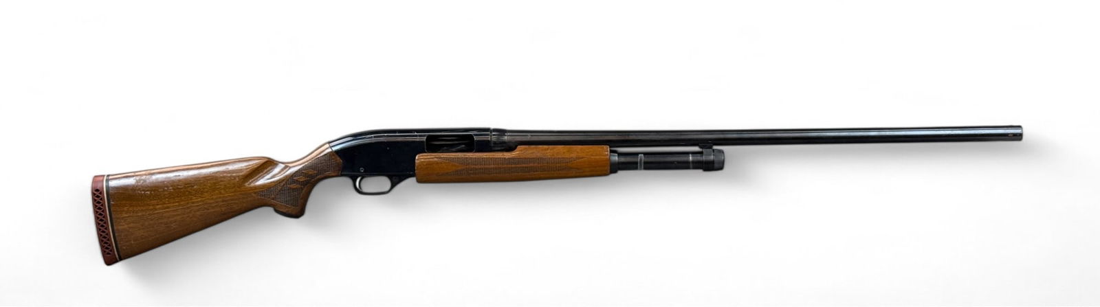 Winchester Model 1200 shotgun, 12 gauge.: A Winchester Model 1200 pump action shotgun, 12 gauge. Blued finish. 28" barrel. Walnut stock. 48 3/4" overall. 14" length of pull. Condition: Fair condition. Heavy wear from use on stock and metal. S