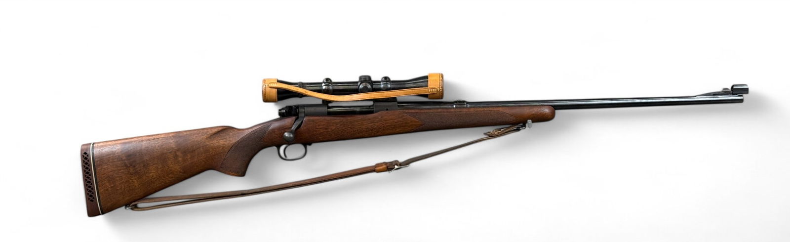 Winchester Model 70 bolt action rifle, .270 Win.: A Winchester Model 70 bolt action rifle, .270 Win. Circa 1951. Blued finish. 24" barrel with hooded ramped front sight. Drilled for scope mount. 4 shot magazine. Walnut stock. Includes Buehler scope m