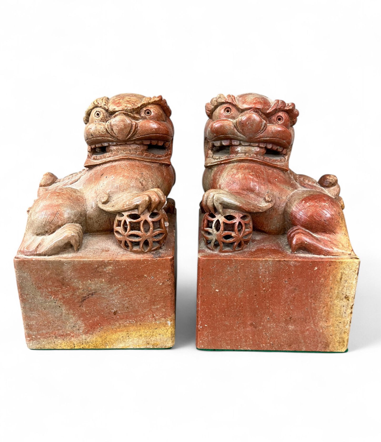 2 Hardstone seal carvings of Foo lions.: A pair of hardstone seal carvings of Foo lions. Late 20th century. Each depicting a reclining Foo lion with paw on a brocade ball, atop a square plinth. 7 1/2" x 4 5/8". Condition: Abrasions, surface