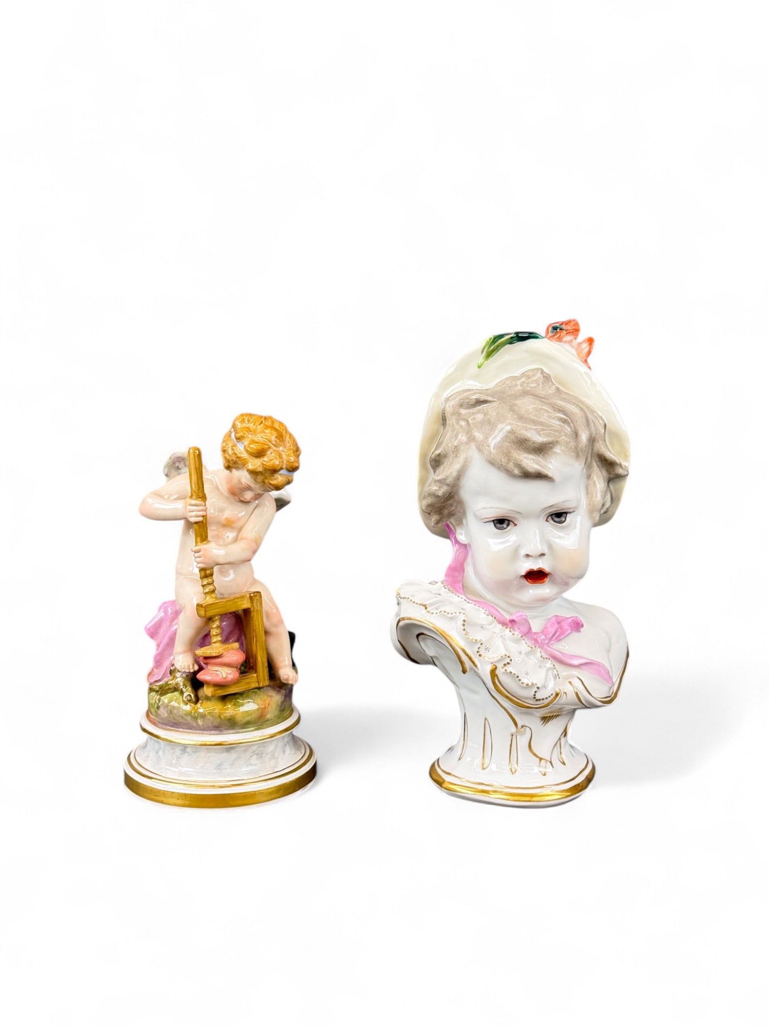 2 German porcelain figures.: A group of two German porcelain figures. Including a bust of a young female and Cupid pressing a heart. Marked on bottom. Smallest: 7 1/2" x 4". Largest: 9 1/4" x 6". Condition: Pigment loss, some dis