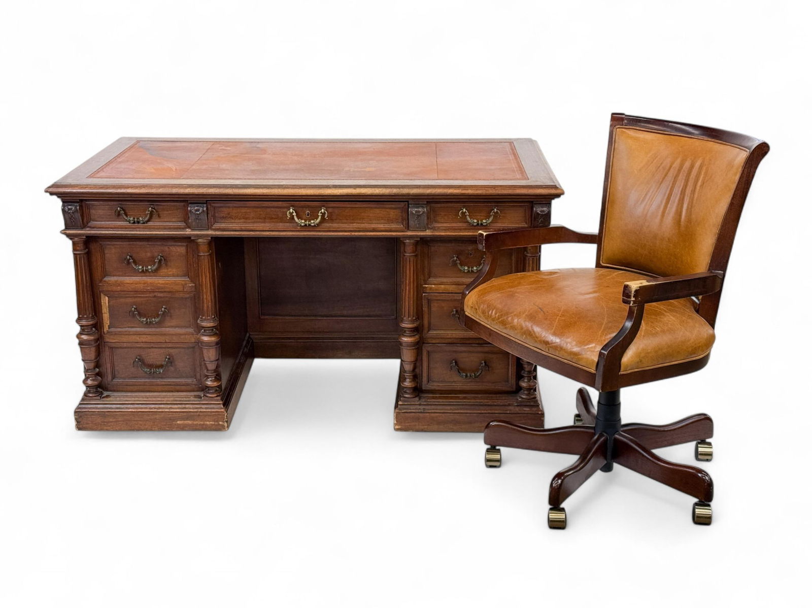 Lt. Gen. James R. Brown, USAF Desk and Chair: A leather-topped executive desk formerly belonging to Lt. Gen. James R. Brown, USAF, together with a leather upholstered swivel chair. The desk features six drawers flanking a central kneehole, with f