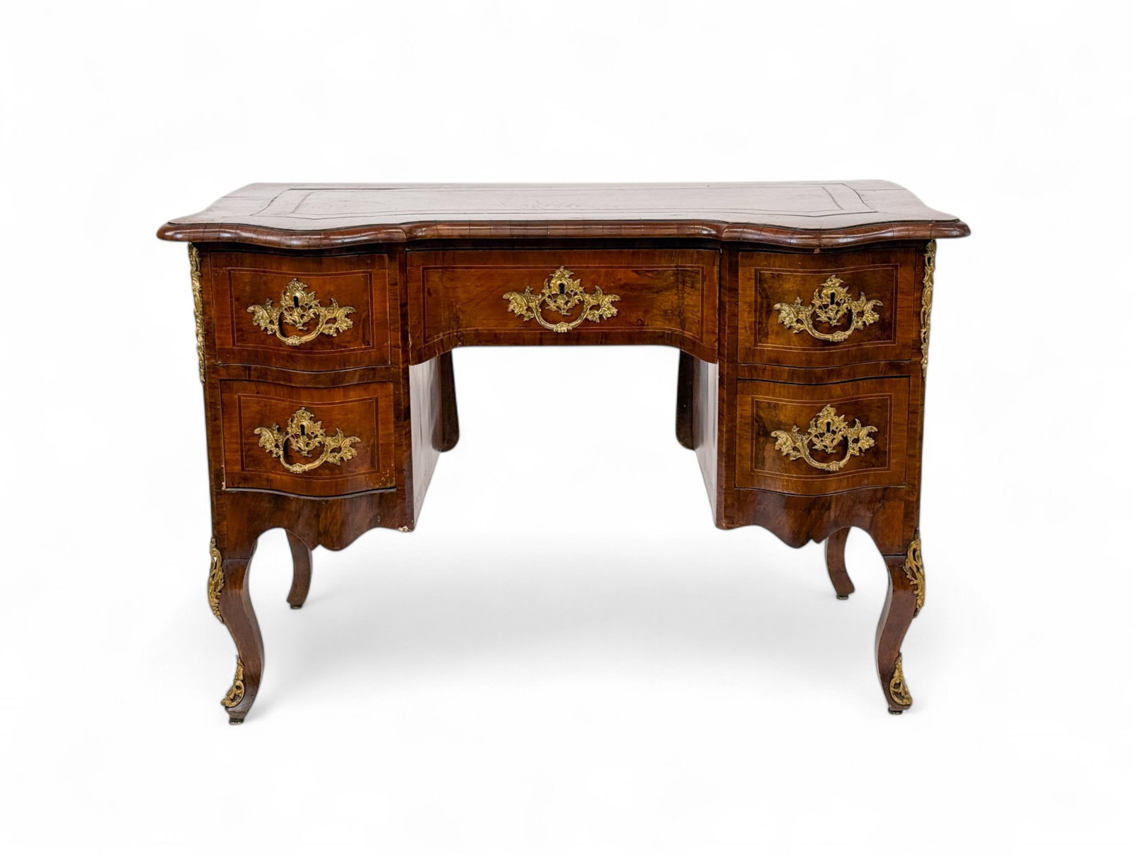 Louis XV style burl walnut desk.: A Louis XV style burl walnut leather topped ormolu mounted five drawer desk. 20th century. Pine secondary. 30 1/4" x 45" x 25 3/4". Condition: Cracking veneer.