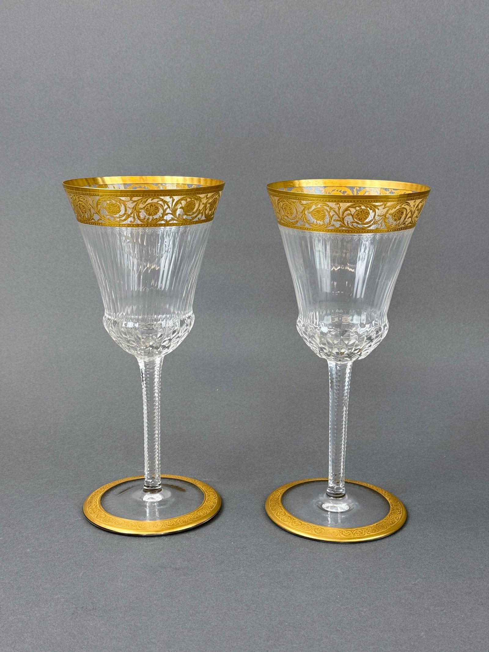 2 St. Louis "Thistle" commemoration glasses.: A pair of St. Louis "Thistle" gilt crystal commemoration glasses. Acid marked on base. Both have sticker. 10 3/8" x 4 6/8". Condition: Residue.