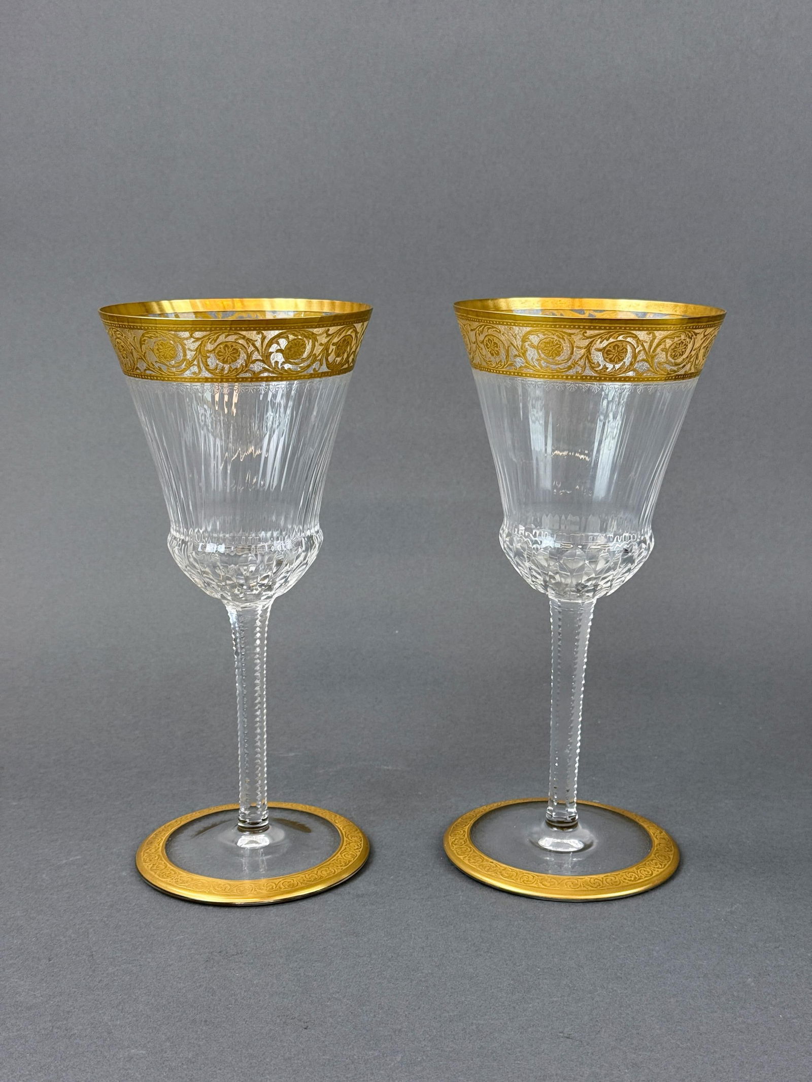2 St. Louis "Thistle" commemoration glasses.: A pair of St. Louis "Thistle" gilt crystal commemoration classes. Acid marked on underside. 10 3/8" x 4 6/8".