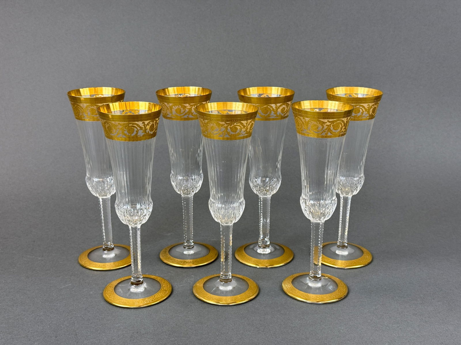 7 St. Louis "Thistle" champagne flutes.: A group of seven St. Louis "Thistle" gilt crystal champagne flutes. Acid marked on base. 7 1/2" x 2 3/4".
