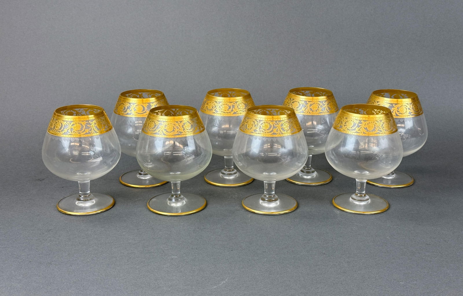 8 St. Louis "Thistle" brandy snifters.: A group of eight St. Louis "Thistle" gilt crystal brandy snifters. Acid etched on base, two with strikes through. 5 1/4" x 3 1/2". Condition: Residue.