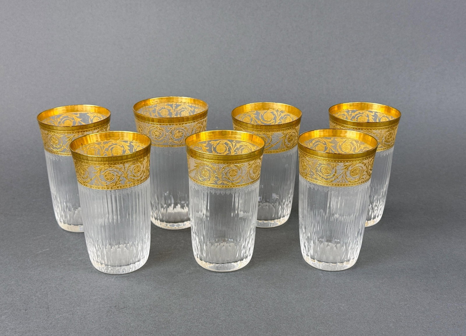 7 St. Louis "Thistle" water tumblers.: A group of seven St. Louis "Thistle" gilt crystal water tumblers. Six 4 5/8" x 2 3/4" and one 4 7/8" x 2 5/8". Condition: Wear on lips.