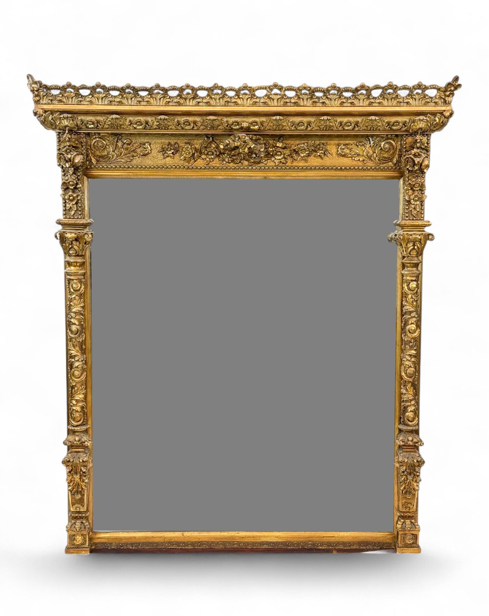 Monumental gilt mantle mirror.: A monumental gilt mantle mirror. Pierced gallery with floral and foliate decoration with . 72" x 63" x 8".