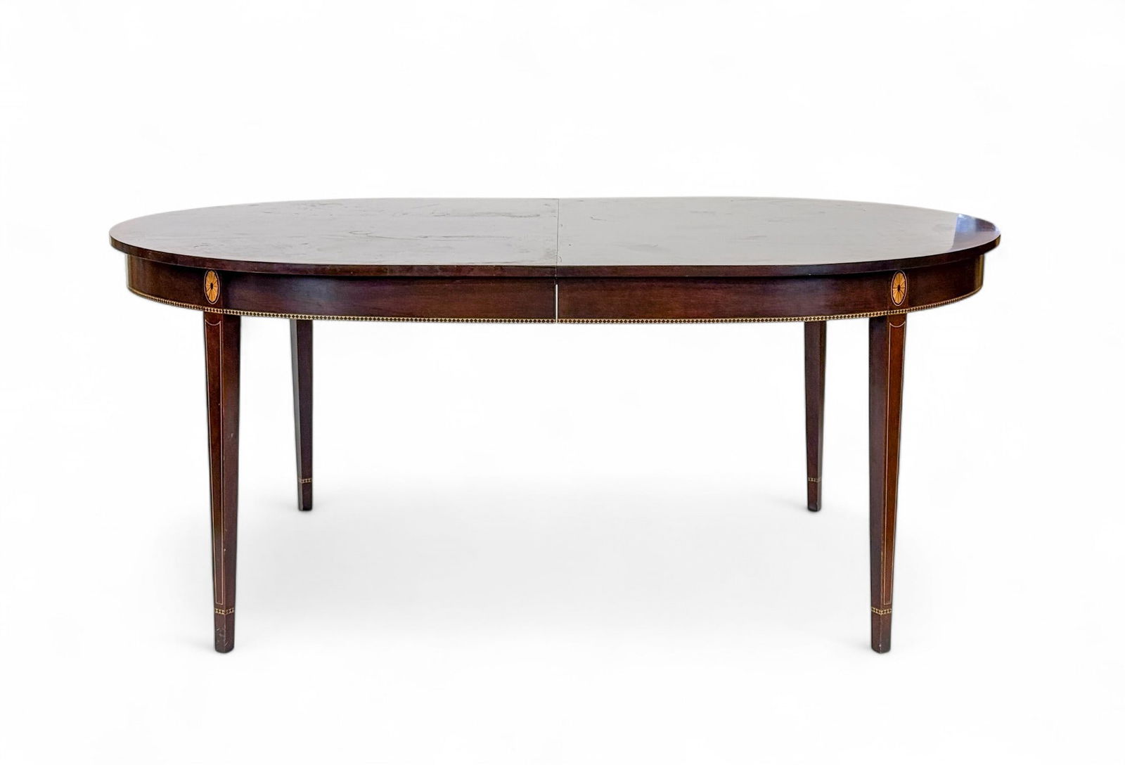 Stickley Federal style mahogany table.: A Stickley Federal style mahogany table. Satinwood inlay. Two leaves. 30" x 71 1/2" x 46". Condition: Scratches on top. Scratches on top. Rails screws stripped from bottom.