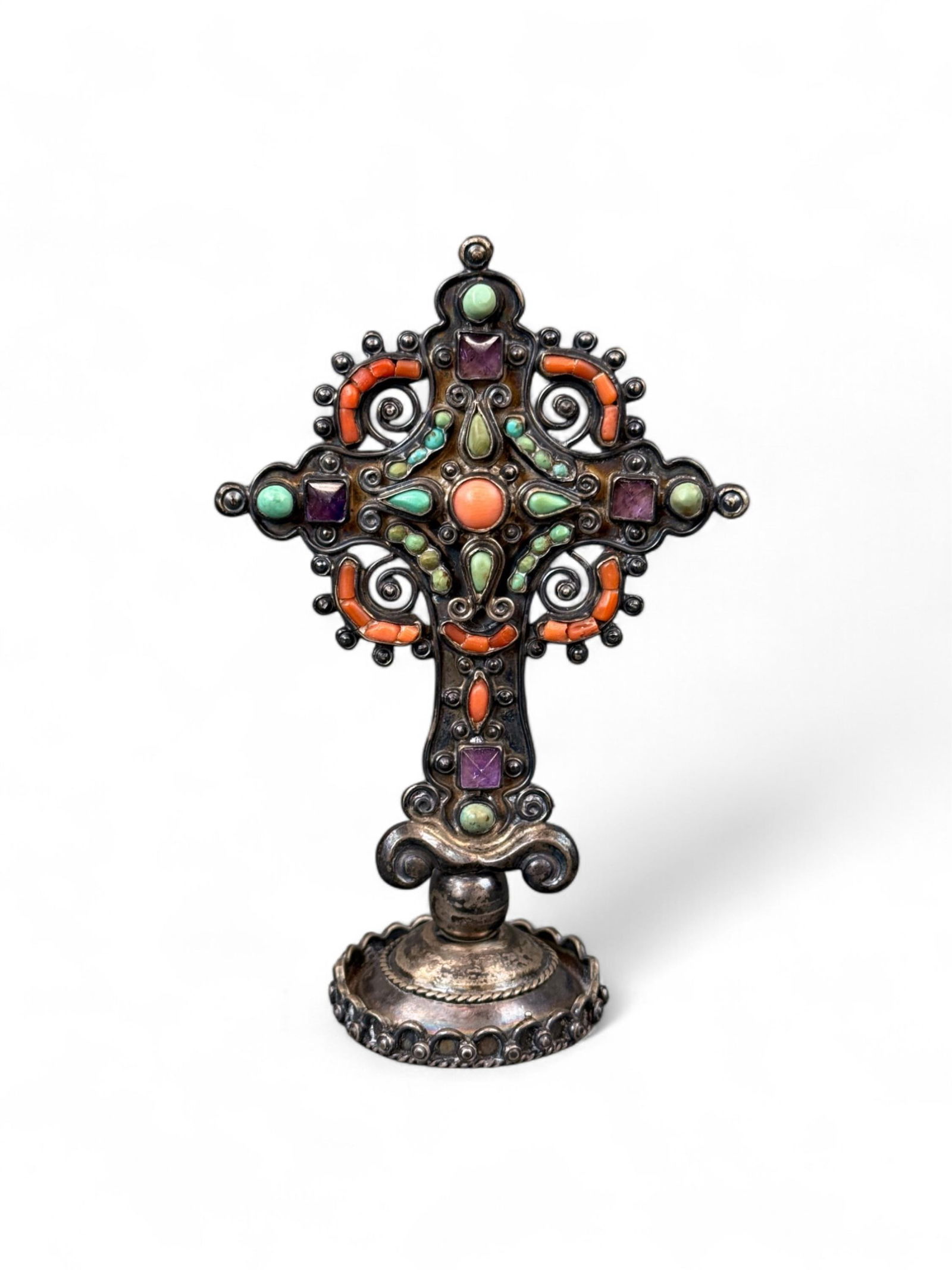 Poulat, Jeweled silver cross.: Poulat, Matilde "Matl" (d. 1960). A Mexican sterling silver cross decorated with cabochon semi-precious stones including turquoise, coral, and amethyst. Stamped "Matl 925." Mexico. 5 3/4".