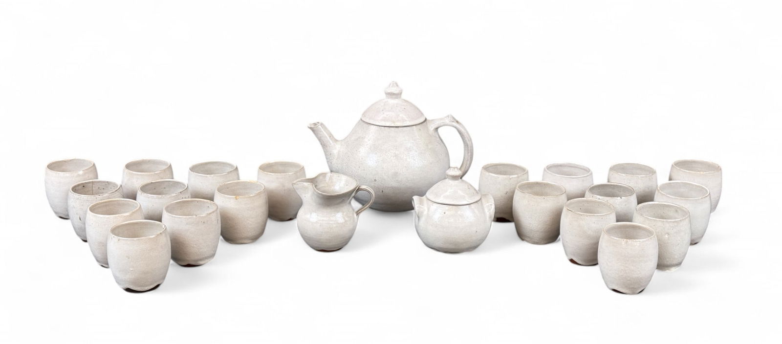 Ben Owen Jugtown ware tea set.: A collection of Ben Owen Master Potter Jugtown ware pottery tea set. Teapot, creamer, lidded sugar and twenty cups all in white glaze. Stamped on base. Smallest: 3" x 2 3/4". Largest: 7 1/2" x 9 3/4".